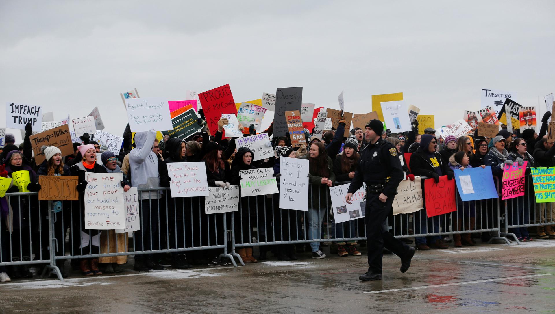 Demonstrators rally against President Donald Trump's refugee and immigration ban during a protest at Detroit Metropolitan Airport in Romulus, Michigan, Jan. 29, 2017.