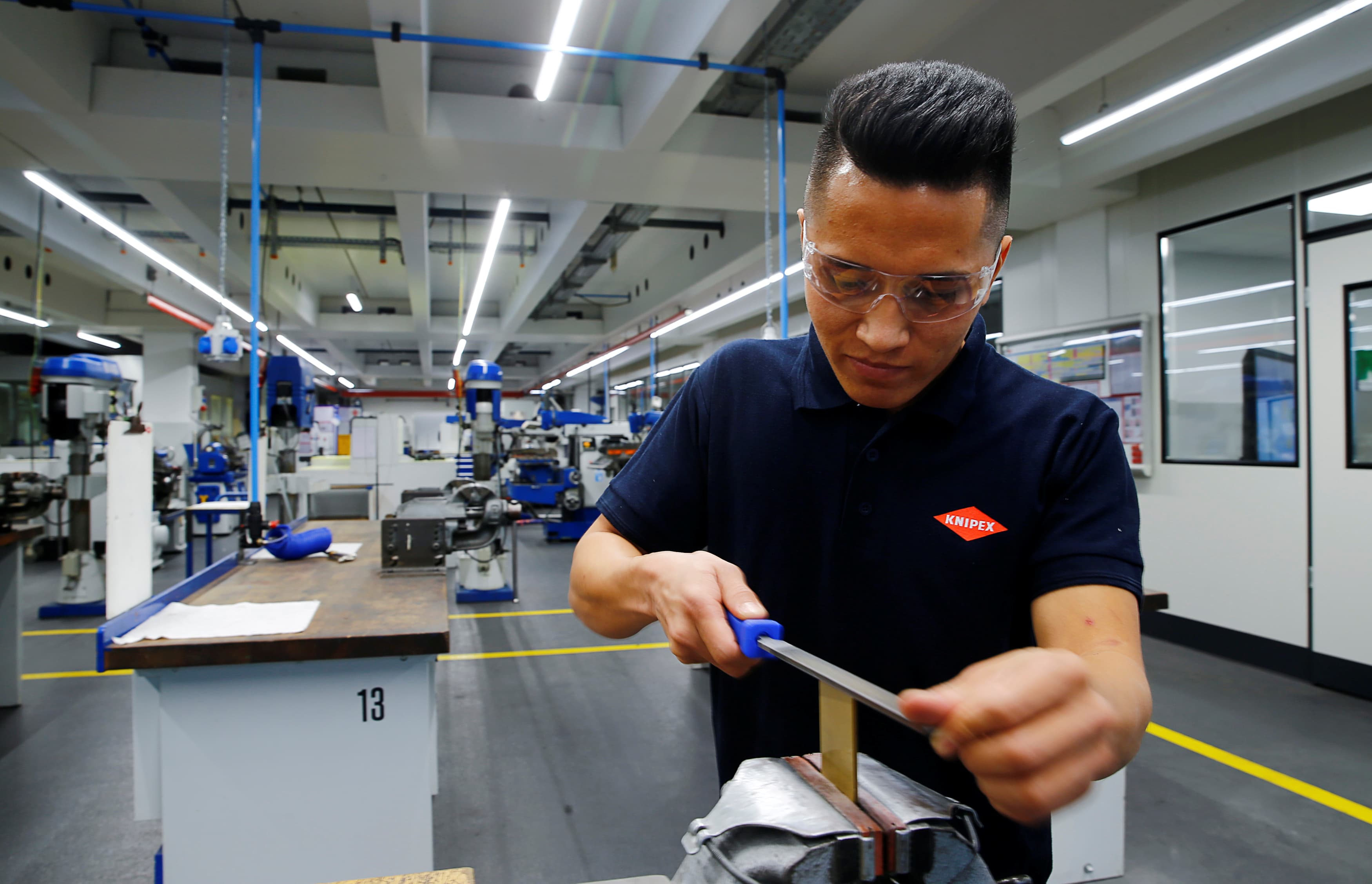 Ahmad Hosseini, an 18-year-old trainee and refugee from Afghanistan, works with a rasp at the training workshop of Knipex, a 130-year-old tool manufacturer in Wuppertal, Germany, Oct. 25, 2016.