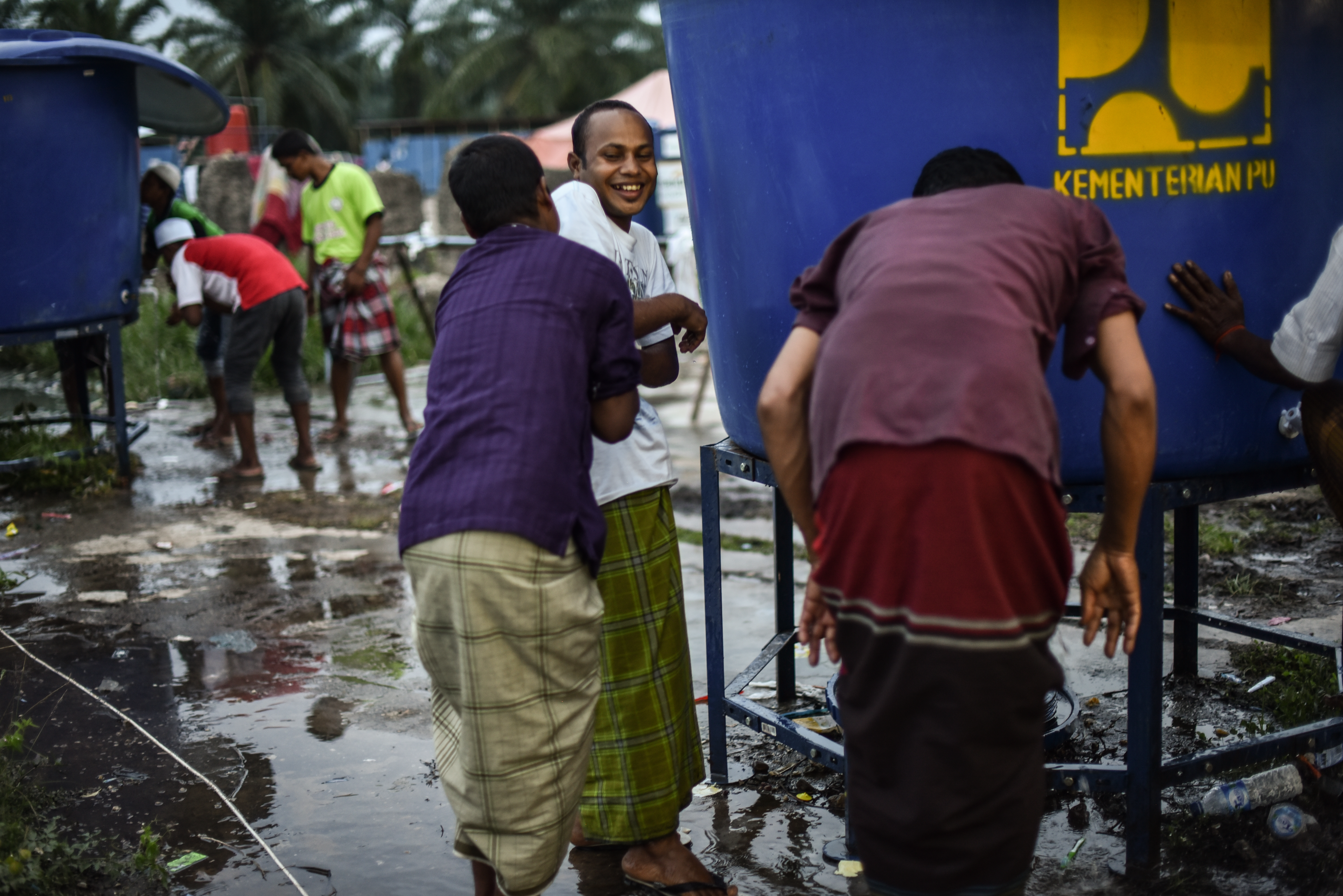 Muslim refugees wash before evening prayer at the Bayeun, East Aceh, Indonesia refugee camp on July 19, 2015.