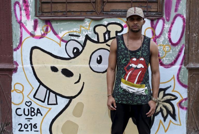 Alberto, 21, wears a shirt with the Rolling Stones logo in Havana.