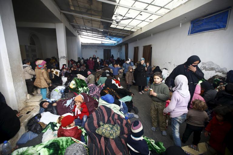 Internally displaced Syrians gather at a shelter near the Bab al-Salam crossing, bordering Turkey's Kilis province, on the outskirts of the northern border town of Azaz, Syria, Feb. 6, 2016.