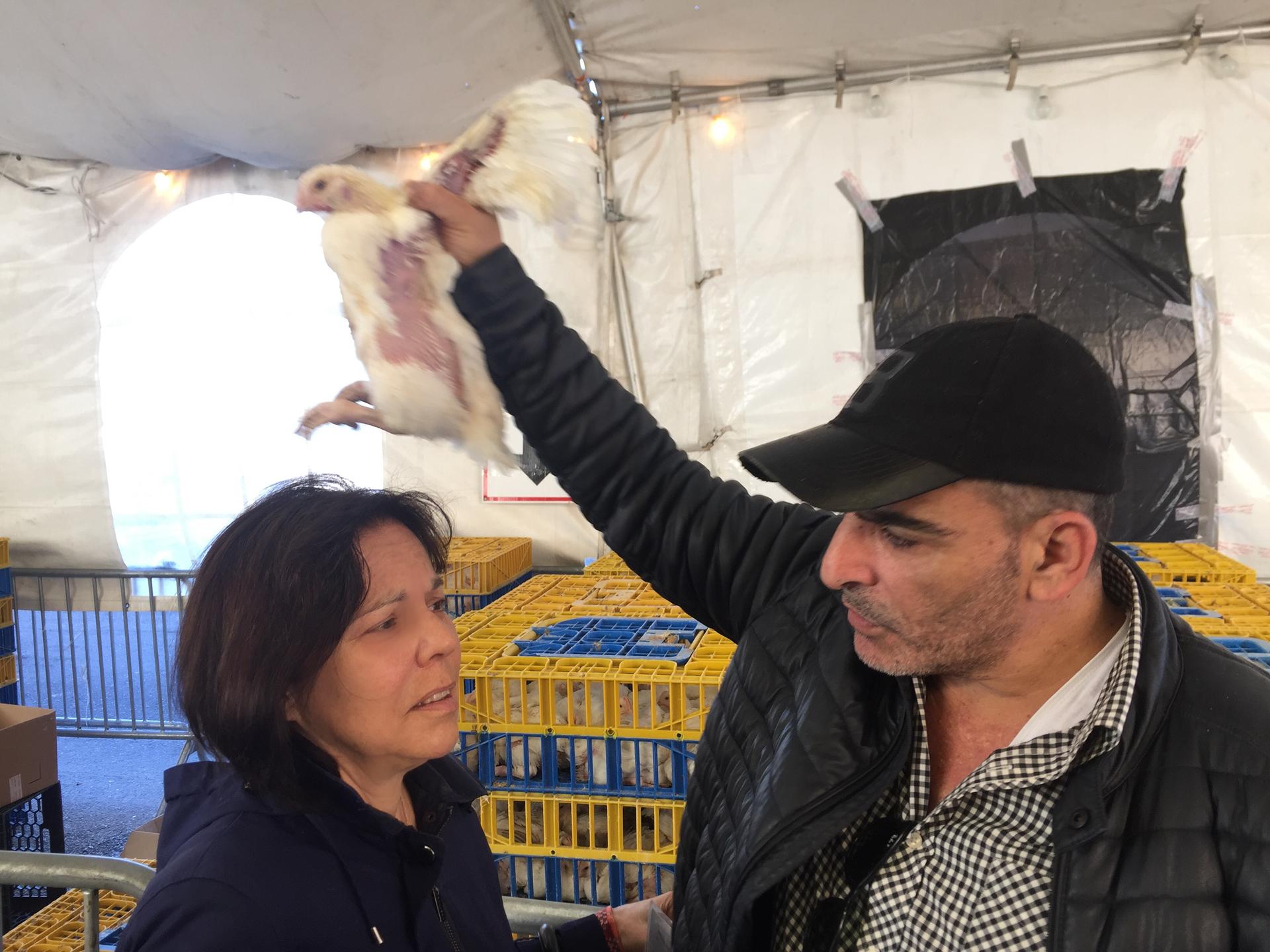 My mother, Barbara Rosenthal, gets some help with the Kaparot ritual. An Israeli man offers to swing the chicken over her while she intones the prayer.