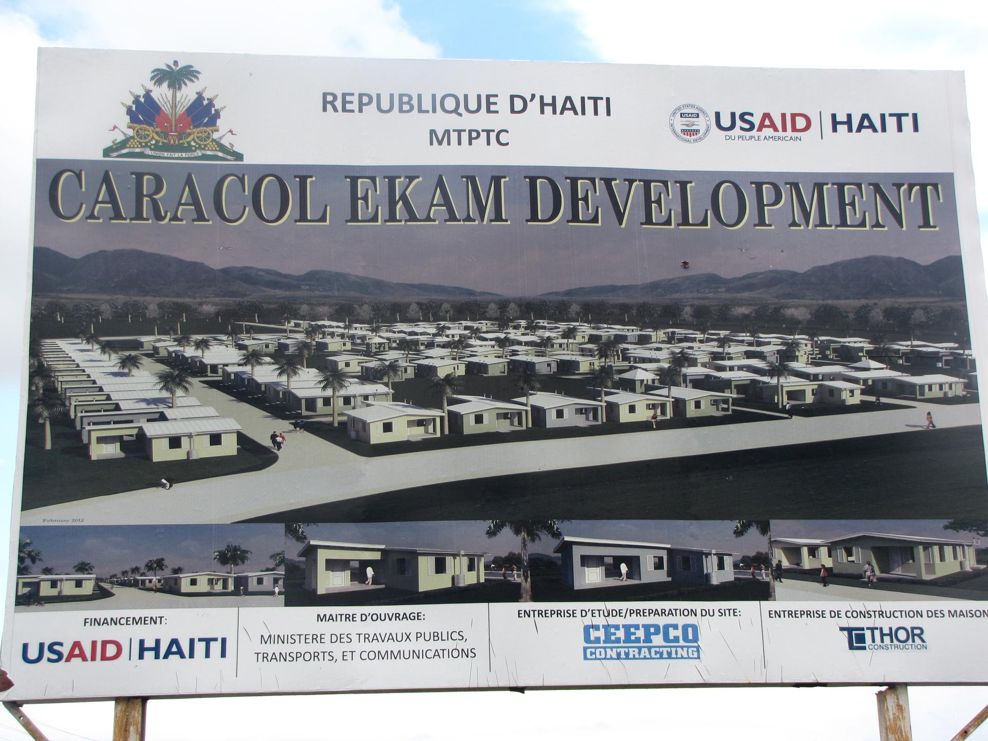 The sign outside Village la Difference, a USAID-funded housing project in Caracol, Haiti.