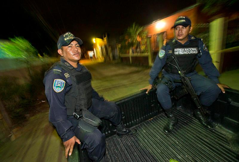 Honduran police officers Edilberto Hernández and Marvin Castro patrol the Chamelecón neighborhood in San Pedro Sula, Honduras.