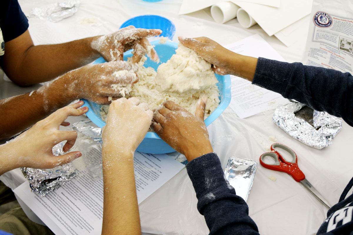 Students at Xavier University in New Orleans blend cucidatta dough in a workshop led by Sandra Scalise Juneau. Over the years, church groups and community members have also started to attend to learn the traditional recipe.
