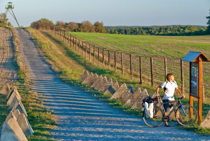 A rider checks a map along the Iron Curtain Trail.