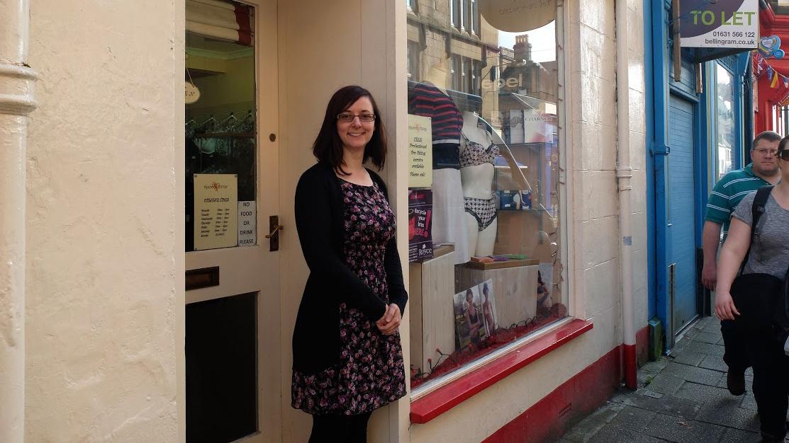 Deirdre Sharkey stands outside of her lingerie shop, Precious Things, in Oban. Sharkey moved to Oban after marrying her Scottish husband — he's also a business owner — and they'll both vote 
