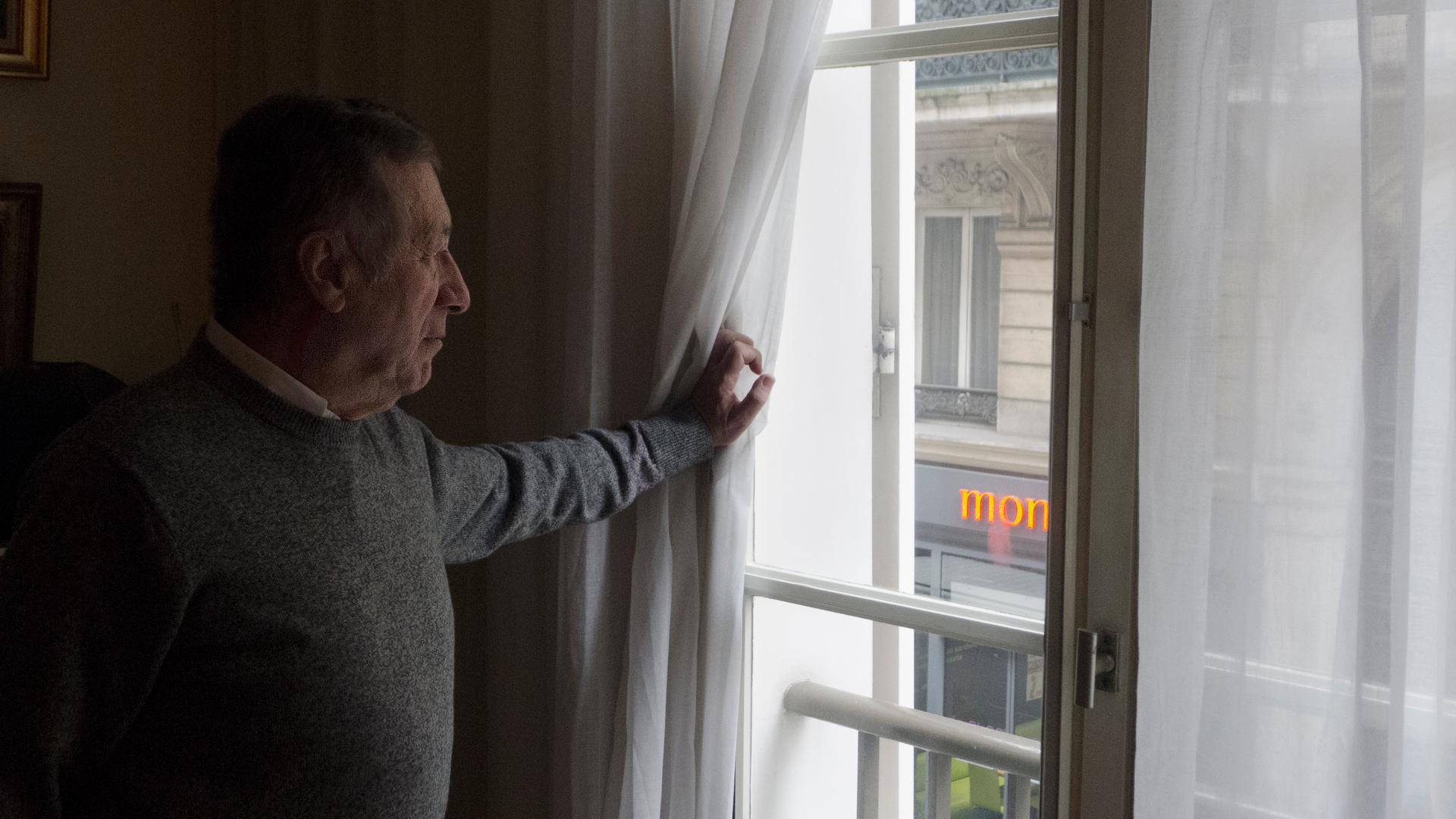 Paris resident and anti-noise activist Gerard Simonet peers through his double-paned windows to the street below. His ears are on constant alert for nocturnal revelers and honking horns.