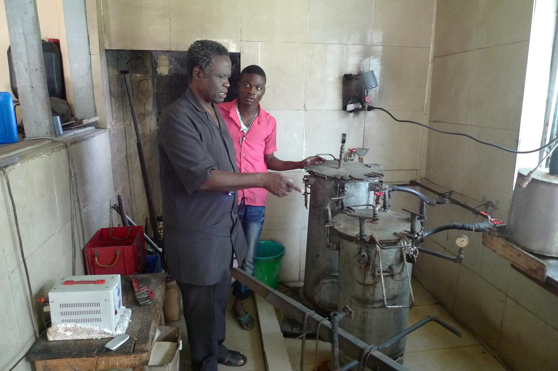Dr. Oluyombo Awojobi inspects the autoclaves at his clinic in Eruwa, Nigeria. The autoclaves, which sterilize surgical equipment, are made from recycled propane cylinders.