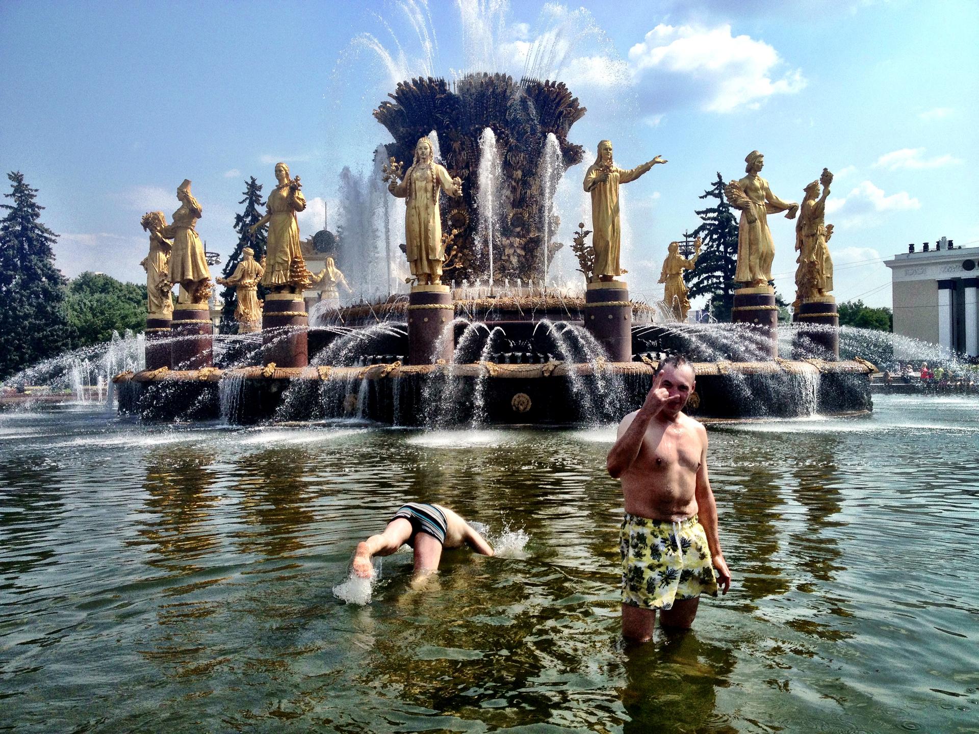 Two former Russian soldiers, Sevold (on the right) and Nikolai (diving), cooling off in a fountain in Moscow's VDNKh Park. Unlike many people in the park, these men expressed some concern about the impact of the new round of sanctions against Russia.  But