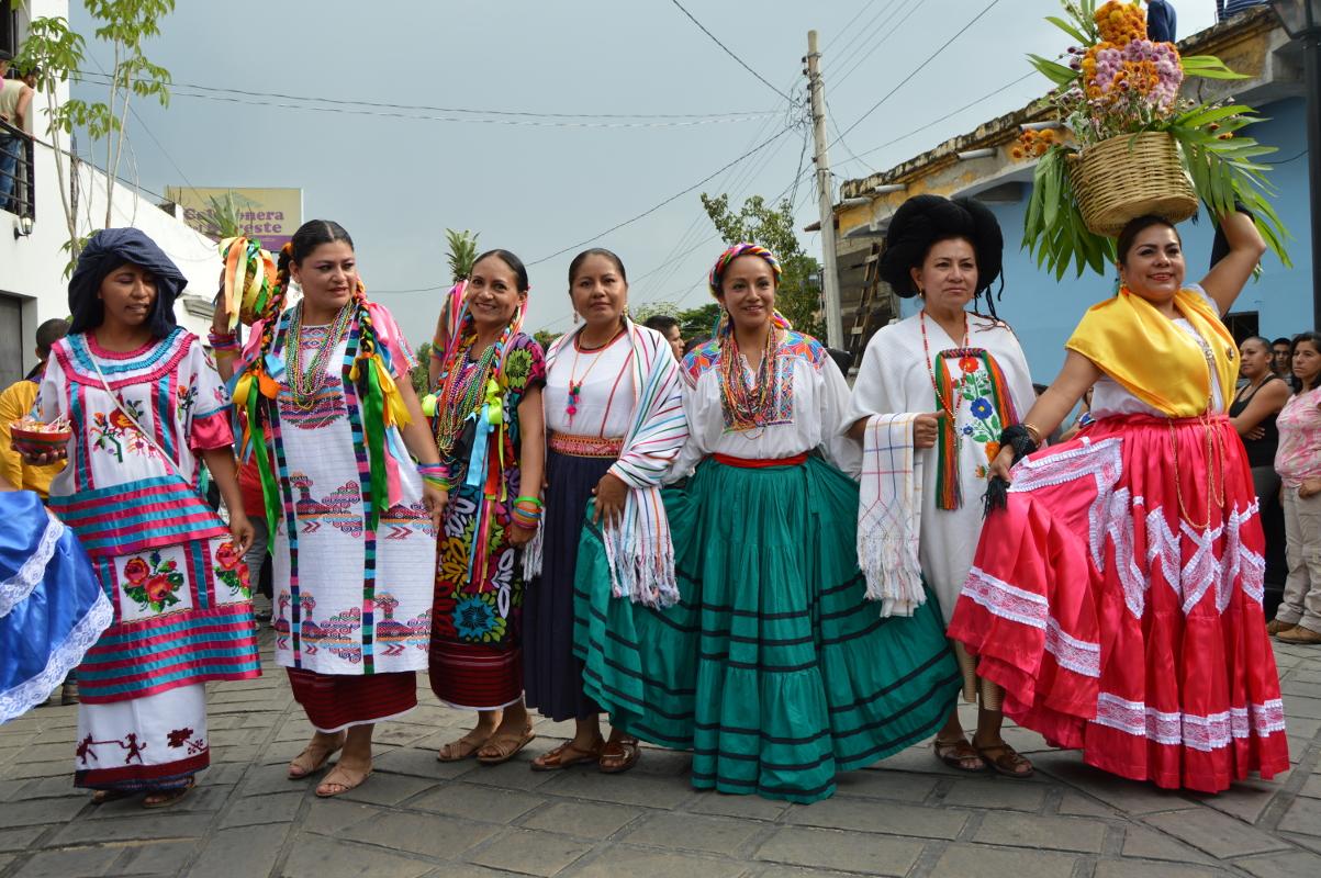 Teachers pose in traditional regional dress from some of Oaxaca's eight regions