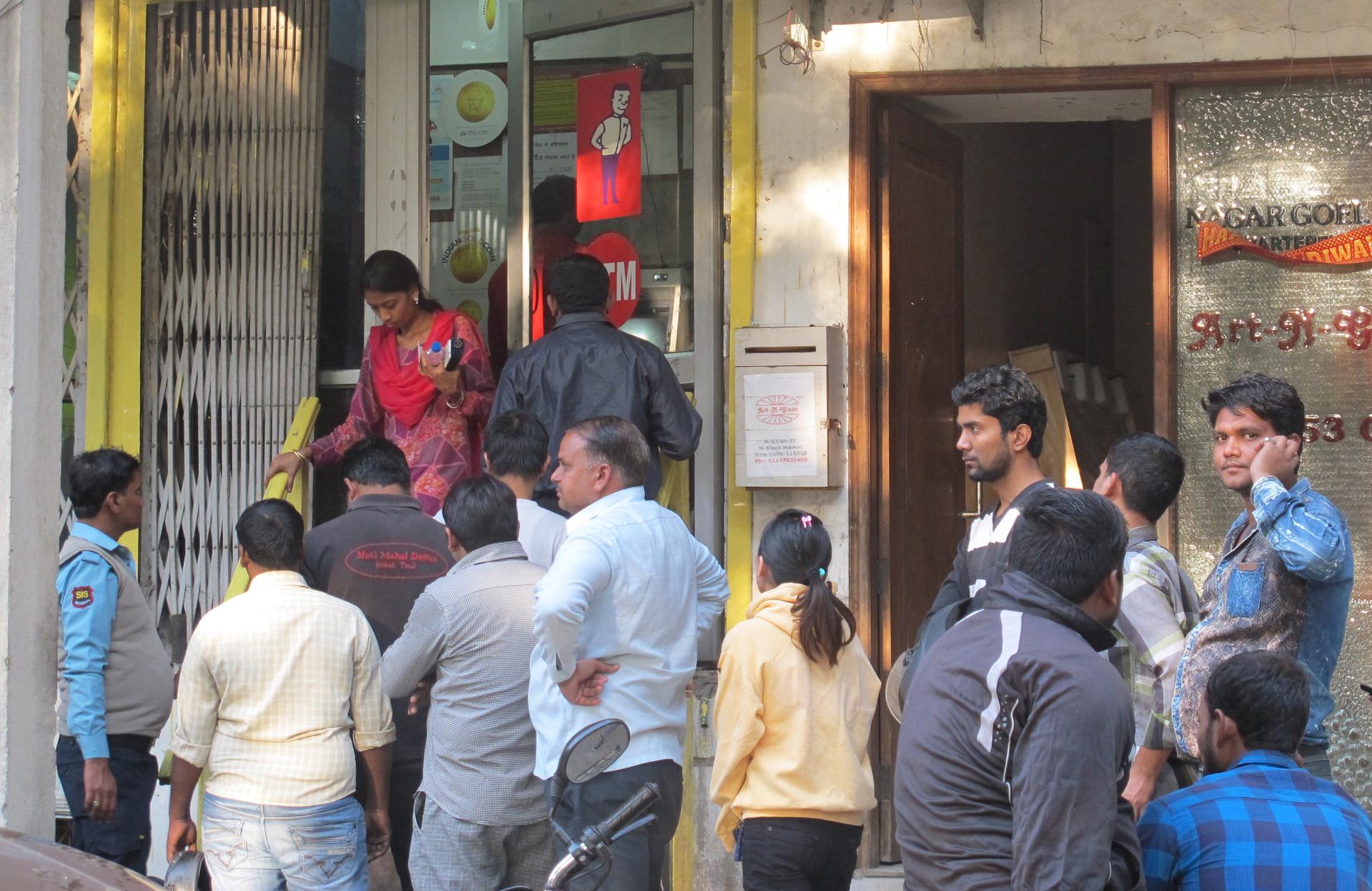 Two weeks after Prime Minister Narendra Modi announced the demonetization of 500 and 1000 rupee currency notes, residents of south Delhi continue to line up in front of ATMs in hopes of withdrawing cash.
