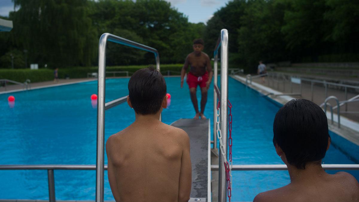 A young swimmer gets ready to leap off of a diving board at Sommerbad Neukolln, a public pool facility in Berlin. It's located in one of Germany’s most ethnically diverse neighborhoods.