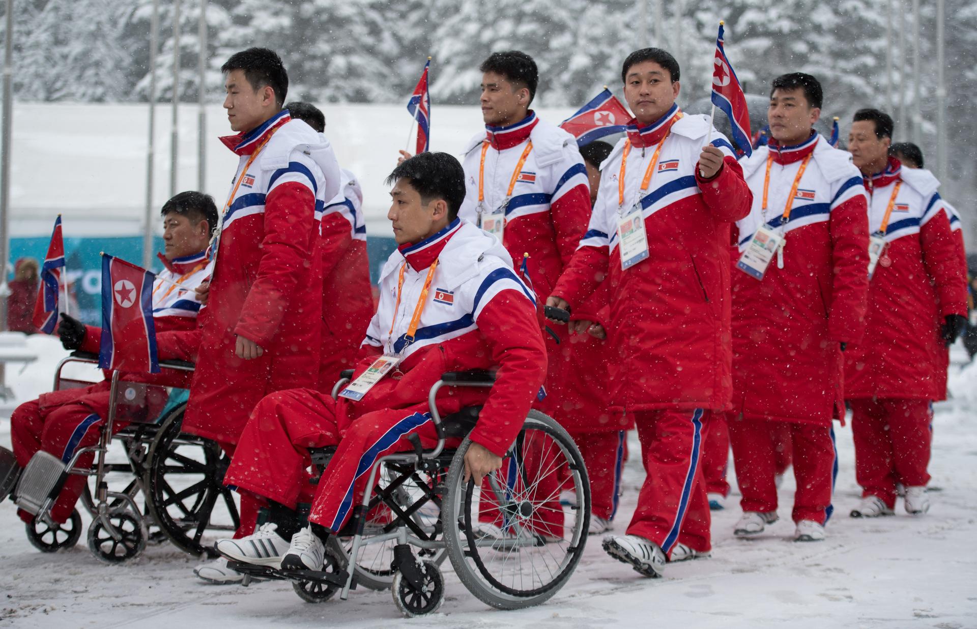 The delegation and the team of North Korea arrive at The Paralympic Village in Pyeongchang, South Korea, wearing red jumpsuits, March 8, 2018. 