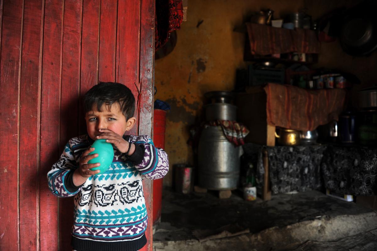 An Afghan boy plays with a balloon at his house in Mazar-i-Sharif in 2014.
