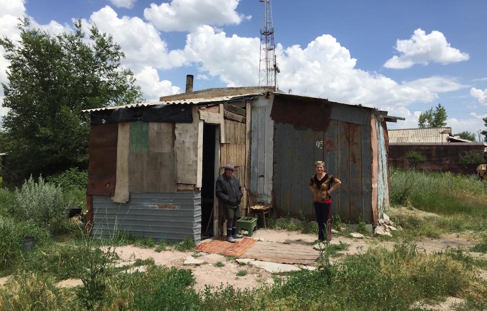 Armenian sisters Arev, left, and Lida stand in front of their home built from a shipping container.