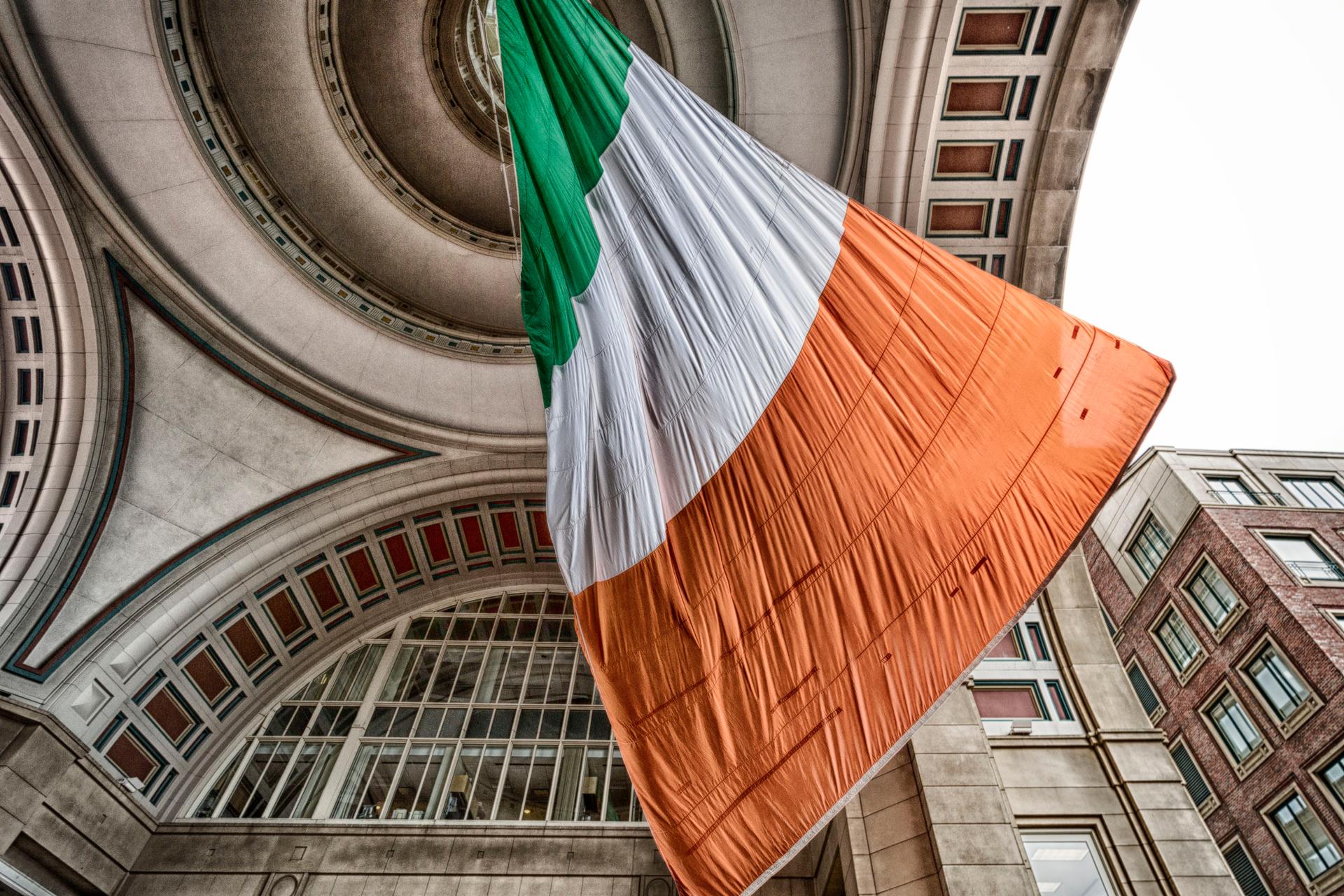 large flag of Ireland hanging in building rafters