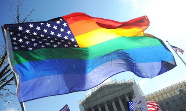 Same-sex marriage supporters wave a rainbow flag in front of the US Supreme Court on March 26, 2013 in Washington, DC