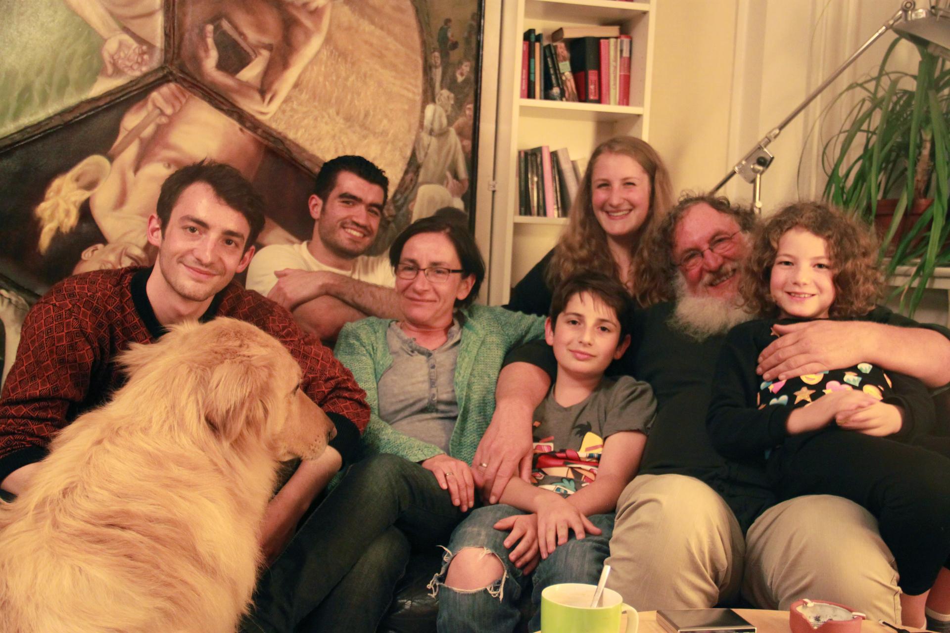 The Jellinek family in their home in Berlin, with their houseguest, Kinan, a Syrian Muslim refugee (second from left). When Chaim Jellinek told Kinan he was Jewish, Kinan said he had no problem with that.