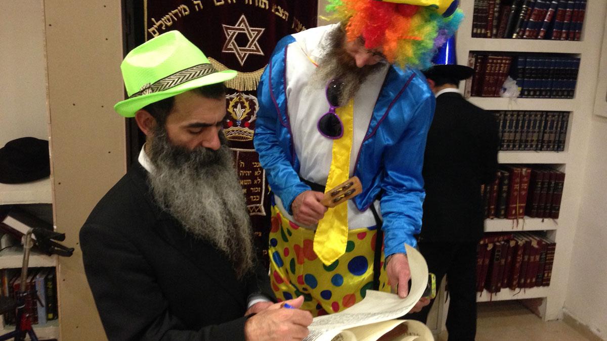Orthodox Jewish men in costume read from a scroll of the biblical Book of Esther for the Jewish carnival holiday of Purim. The story tells the tale of an ancient Persian king whose viceroy hatches a plot to kill the Jews of the kingdom, a plot that is thw