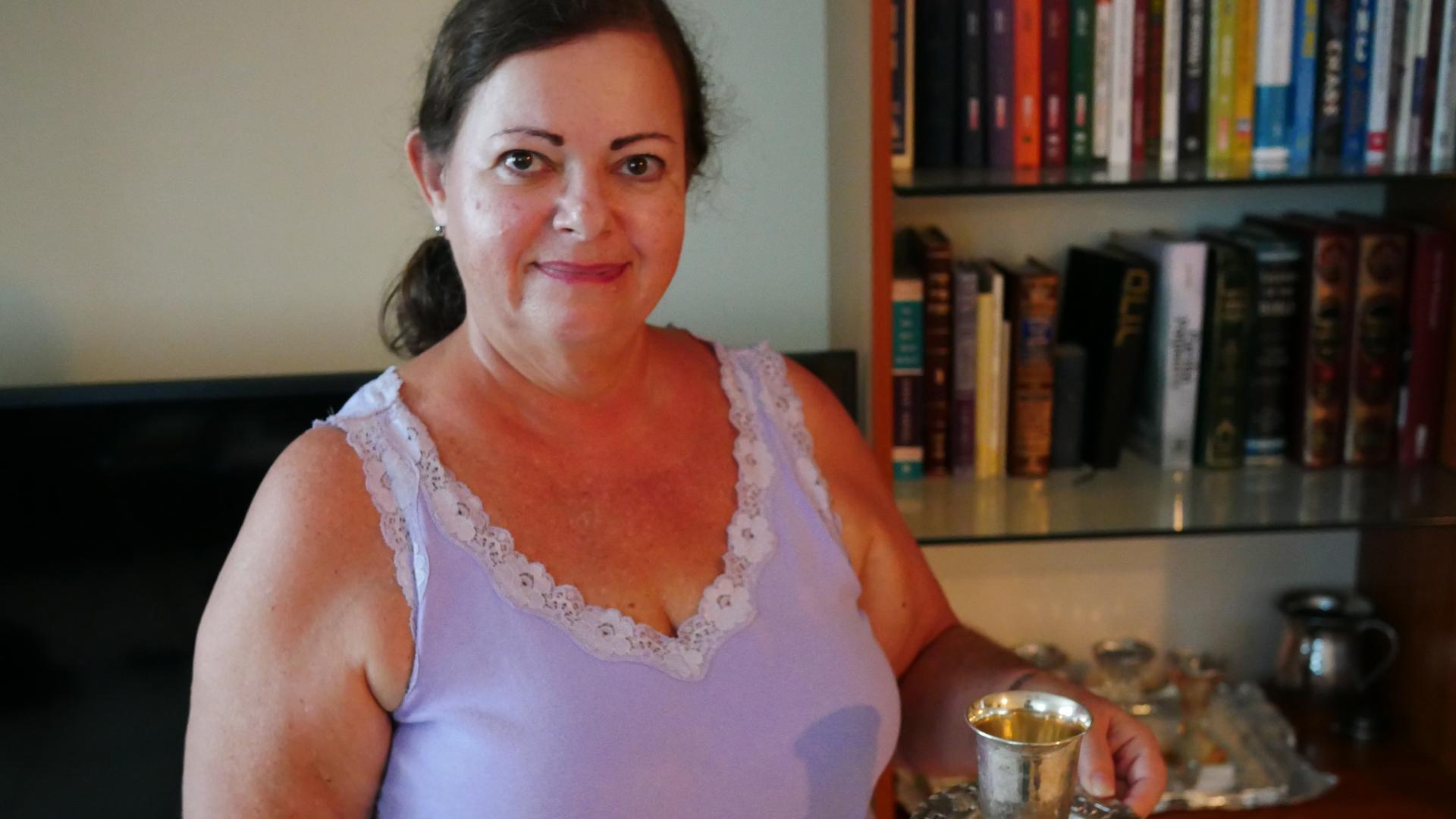 Mely Revai in San Juan, Puerto Rico, holding a ritual kiddush cup she brought from her home Caracas.