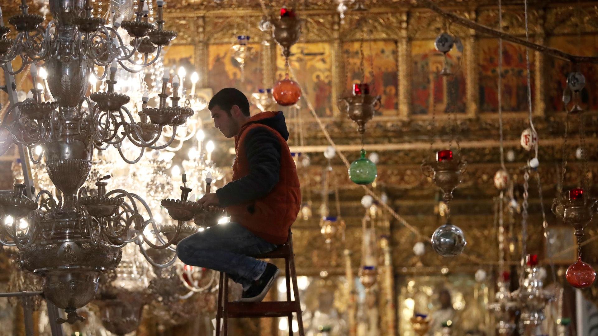 A worker prepares lights ahead of Christmas celebrations in the Church of the Nativity in the West Bank city of Bethlehem, Dec. 19, 2017.