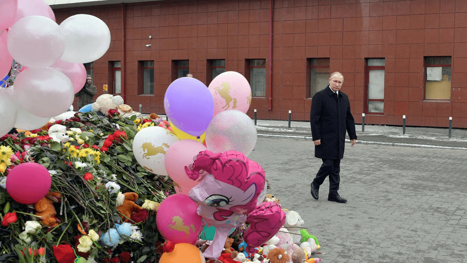 Russian President Vladimir Putin visits the site of fire, that killed at least 64 people at a busy shopping mall, in Kemerovo, Russia, March 27, 2018.