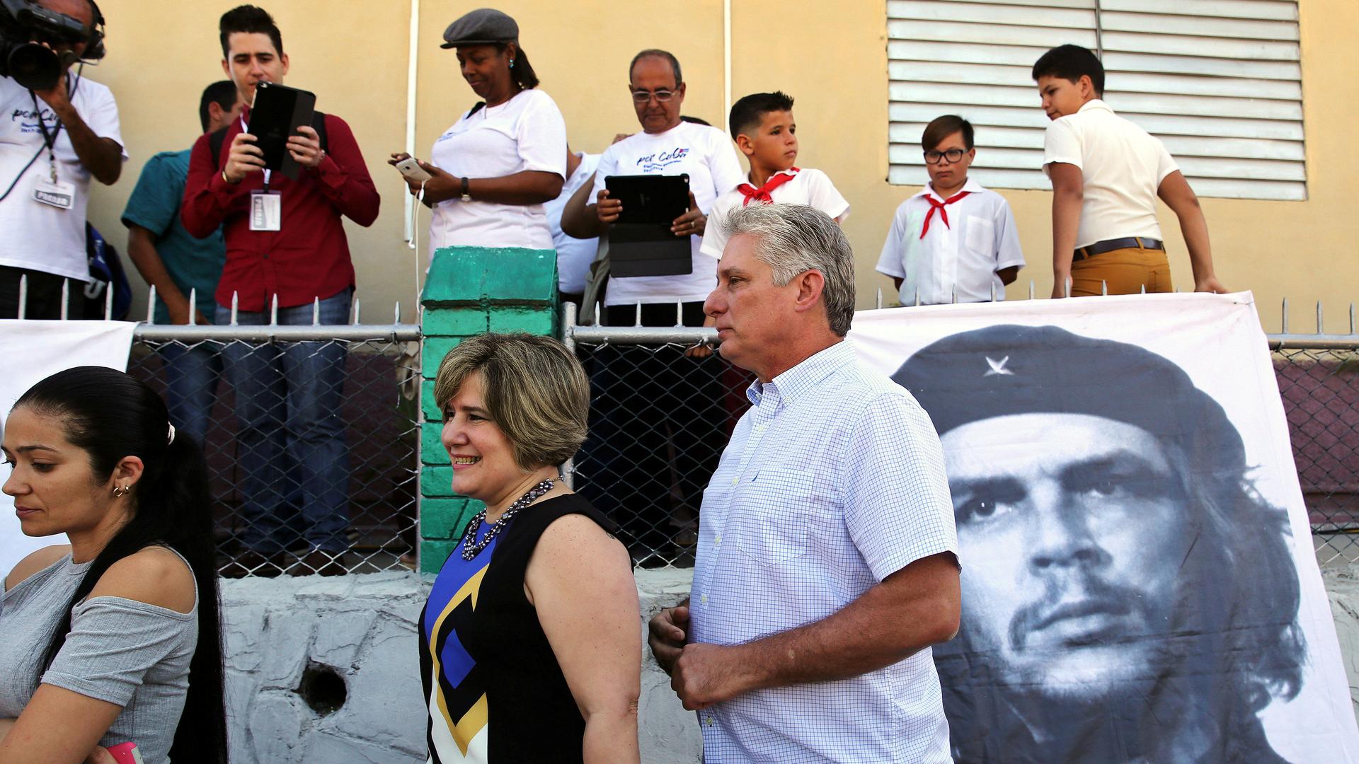 Cuba's First Vice-President Miguel Diaz-Canel and his wife Lis Cuesta stand in line before Diaz-Canel casts his vote during an election of candidates for the national and provincial assemblies.