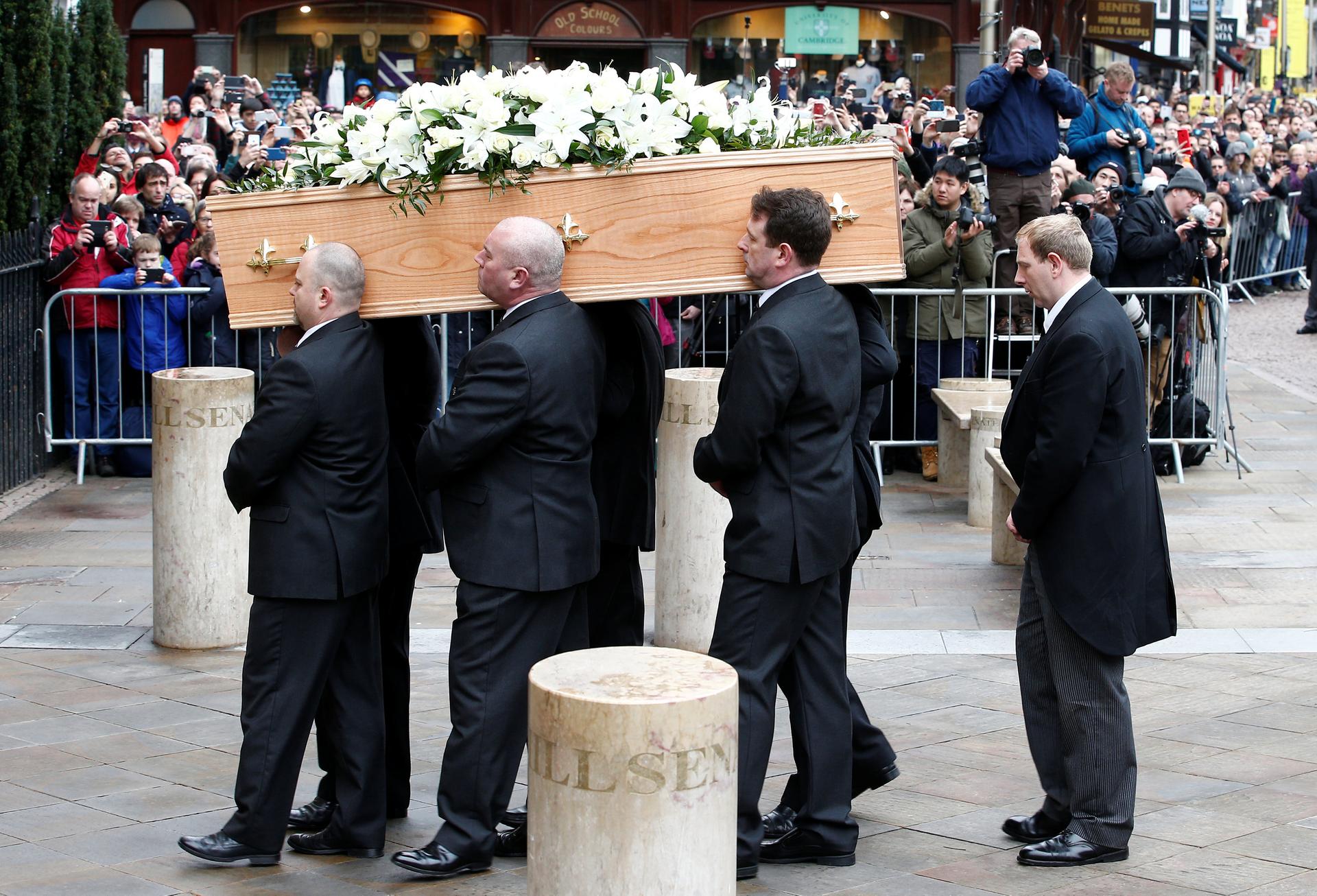 Pallbearers carry the coffin of Stephen Hawking into Great St. Mary's Church.