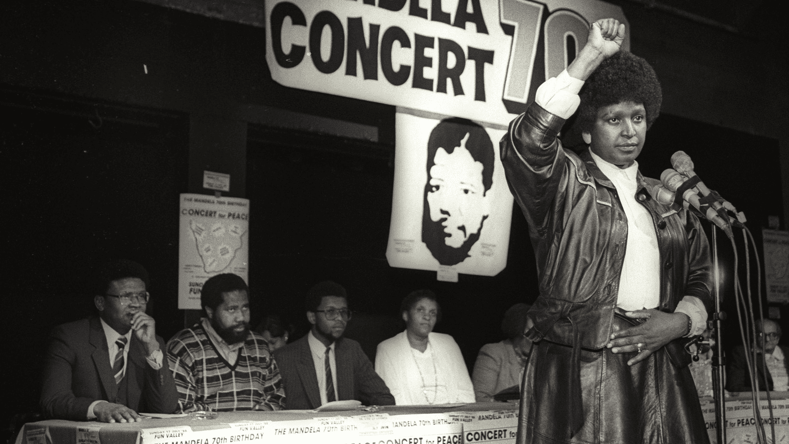 Winnie Mandela raises her fist in a black power salute after announcing that a massive pop concert will be held to mark the 70th birthday of her jailed husband Nelson Mandela, in 1988.