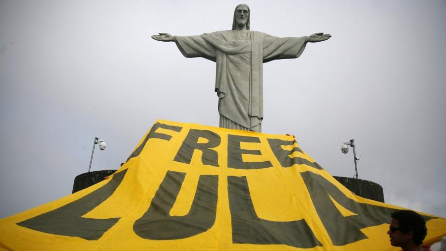 Supporters of former Brazilian President Luiz Inacio Lula da Silva display a banner in front of the statue of Christ the Redeemer in Rio de Janeiro