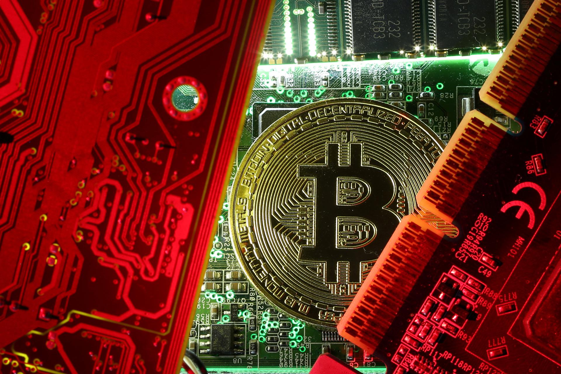  A copy of bitcoin standing on PC motherboard is seen in this illustration picture, October 26, 2017
