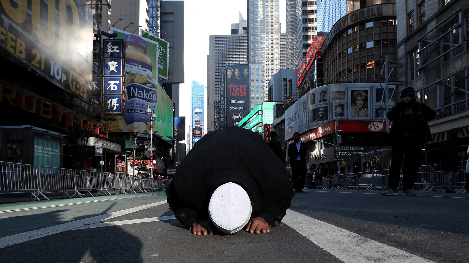 A Muslim man kneels on Broadway Ave. as he takes part in afternoon prayers during an "I am Muslim Too" rally in Times Square, Manhattan, New York, Feb. 19, 2017.