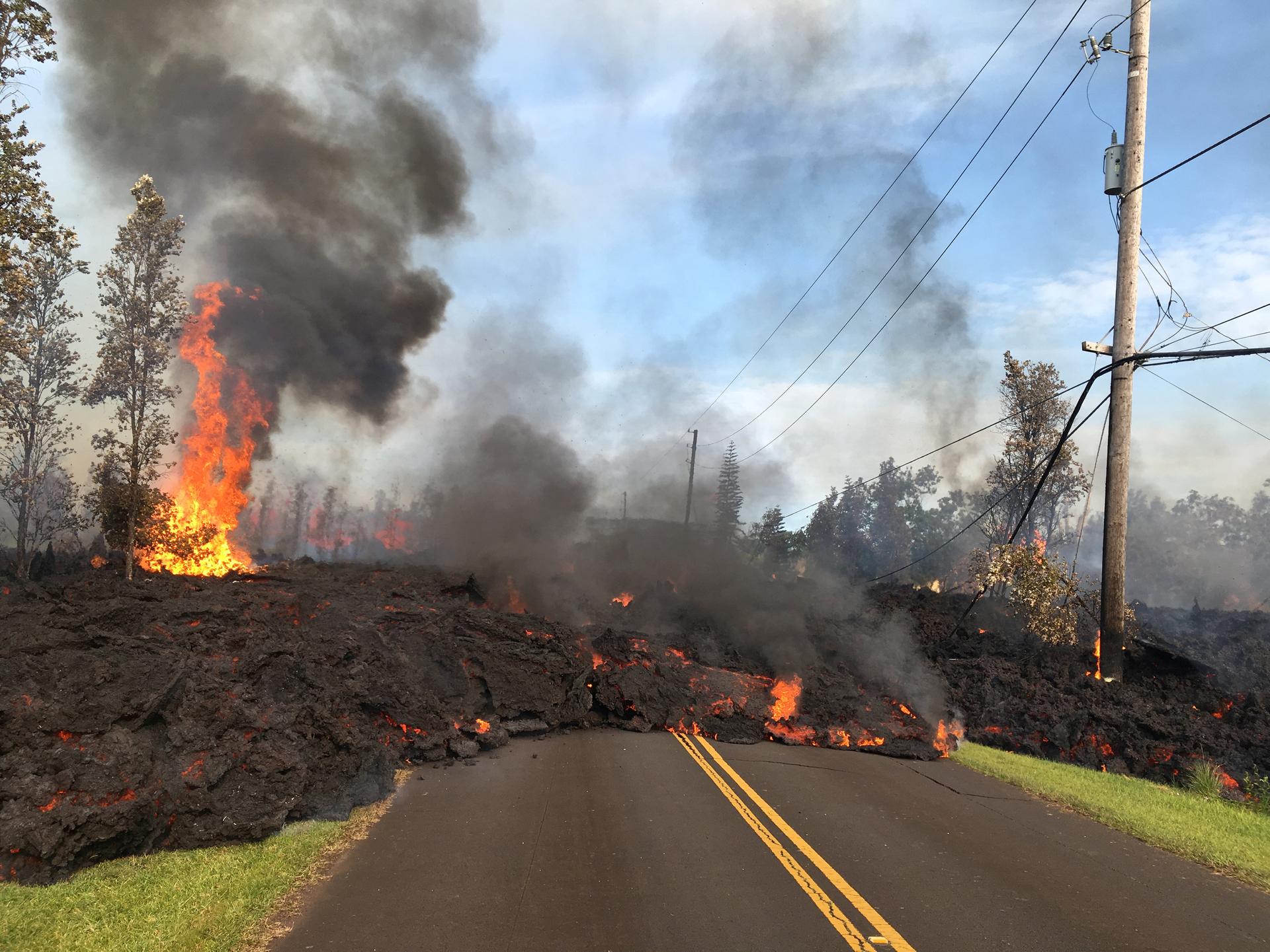 Lava advances along a street near a fissure in Leilani Estates, on Kilauea Volcano's lower East Rift Zone, Hawaii, May 5, 2018. 
