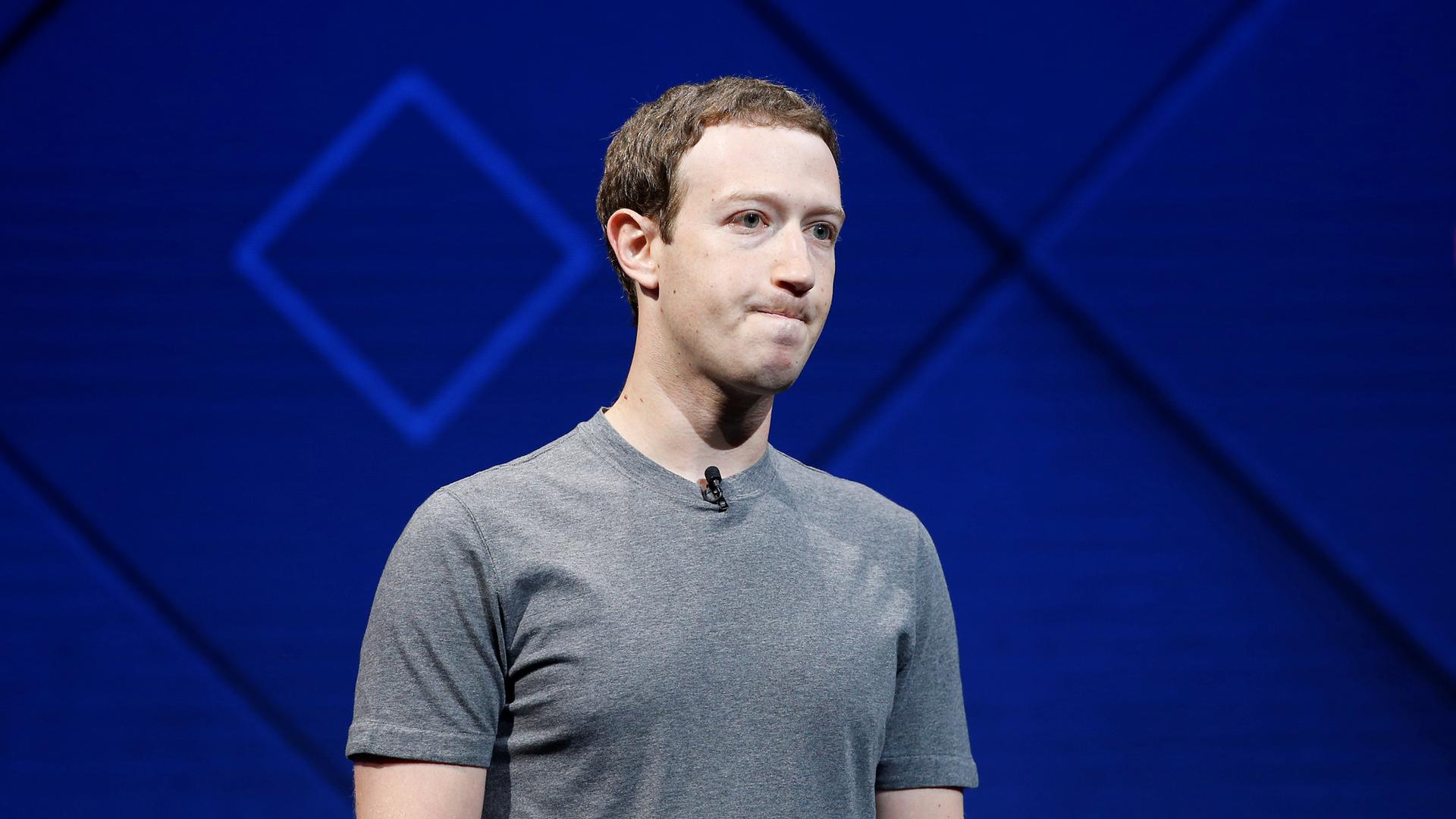 Facebook's Mark Zuckerberg standing on a stage wearing a grey t-shirt, in San Jose, Calif., 2017. 