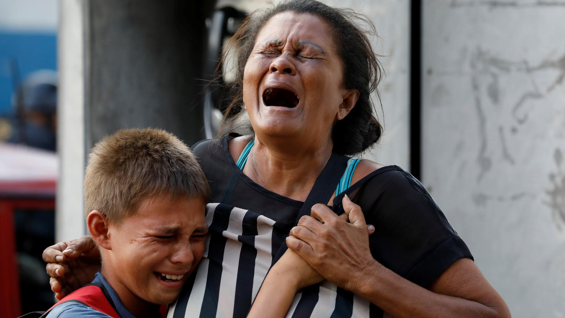 Relatives of inmates held at the General Command of the Carabobo Police react as they wait outside the prison, where a fire occurred in the cells area, according to local media, in Valencia, Venezuela, March 28, 2018.