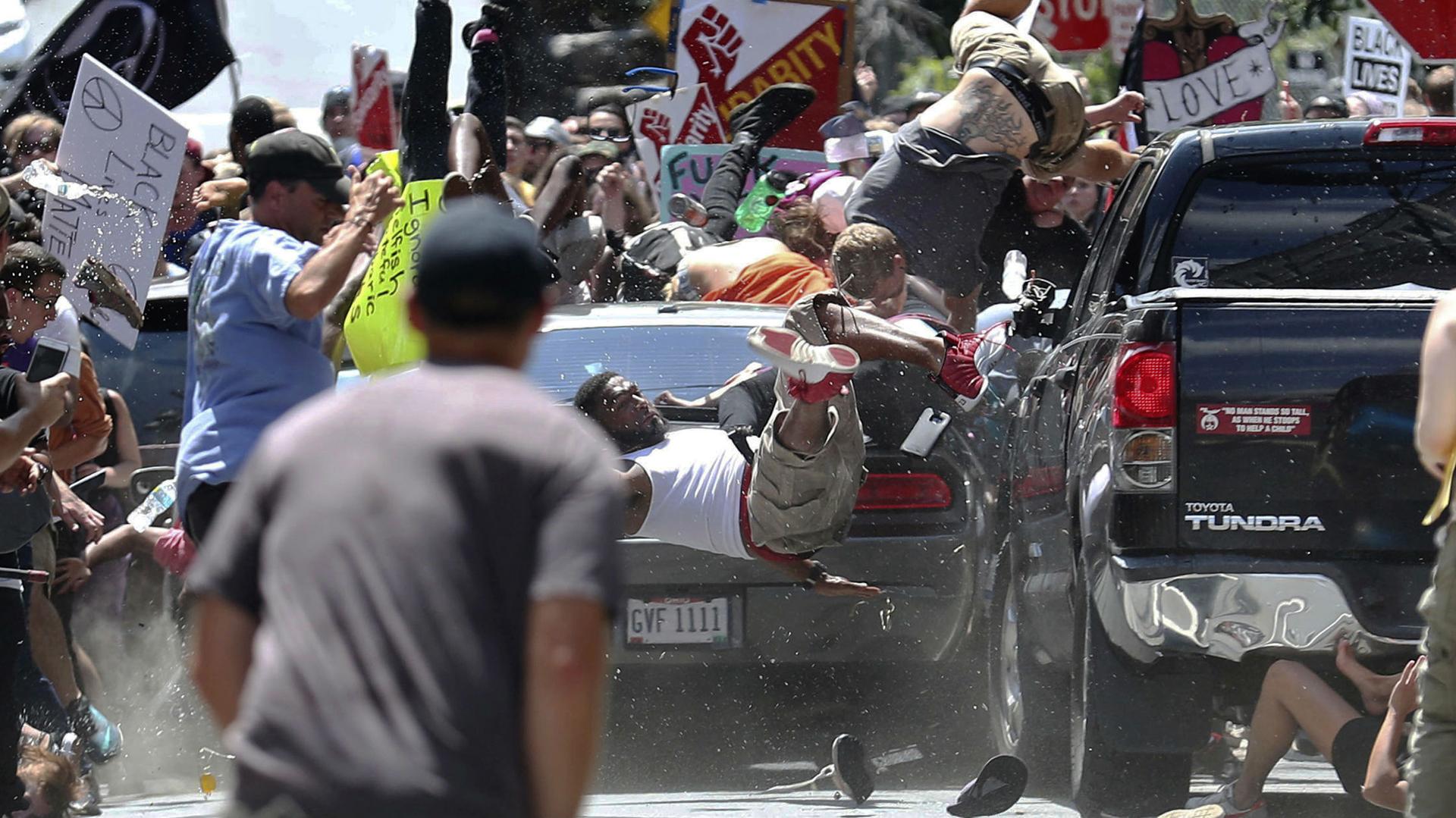 People fly into the air as a vehicle is driven into a group of protesters demonstrating against a white nationalist rally in Charlottesville, Virginia, in August 2017.
