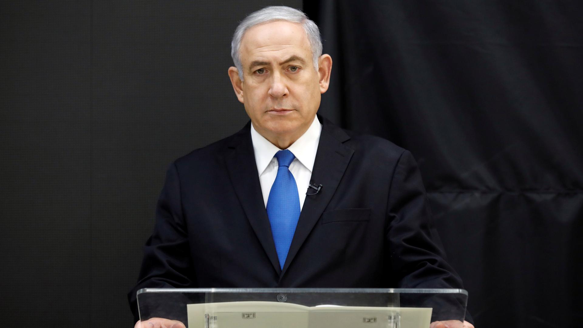 Israeli Prime Minister Benjamin Netanyahu stands at a podium speaking during a news conference in Tel Aviv.
