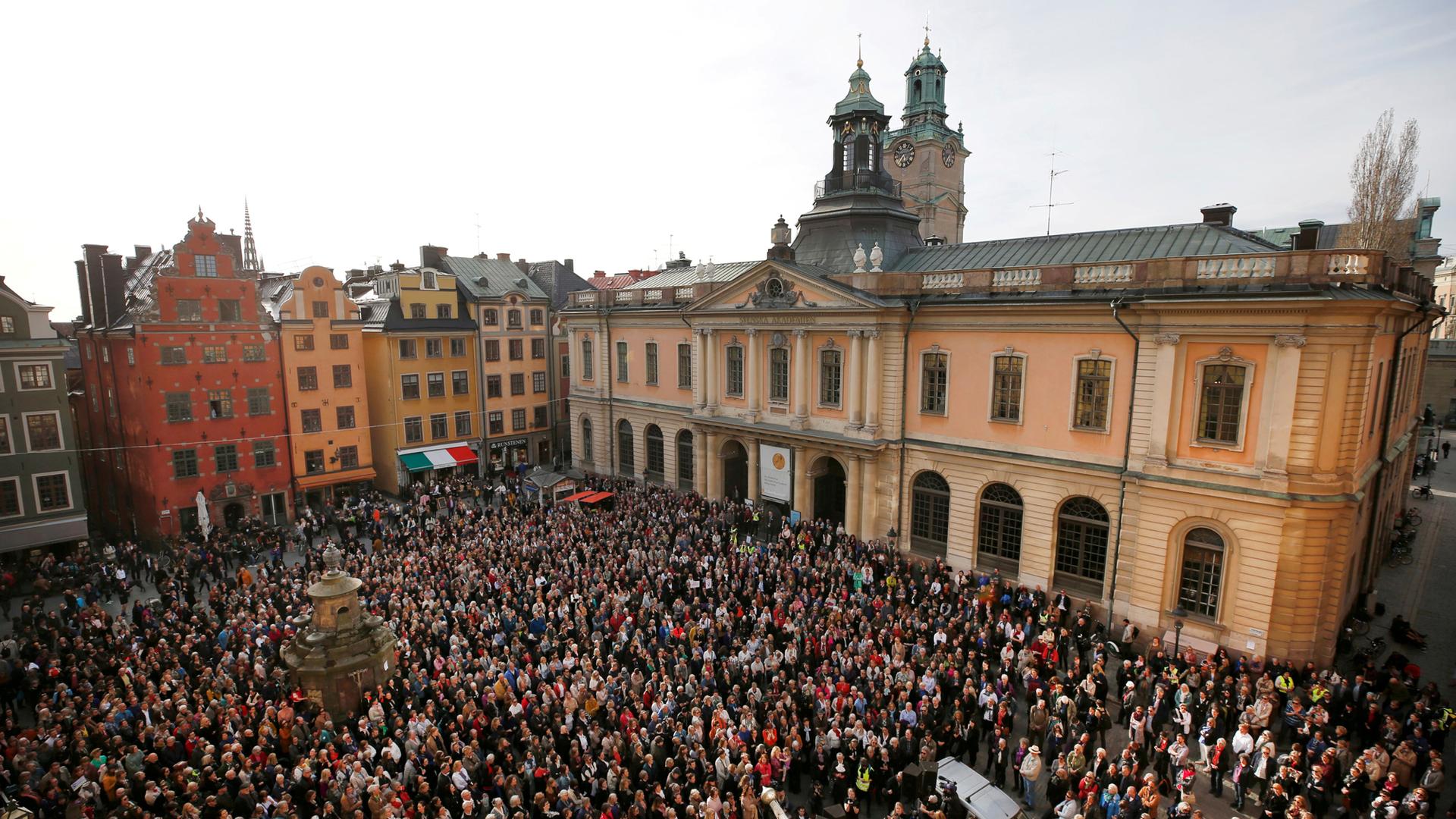 People gather in Stortorget square in Stockholm showing support for former Academy member and Permanent Secretary Sara Danius who stepped down last week.