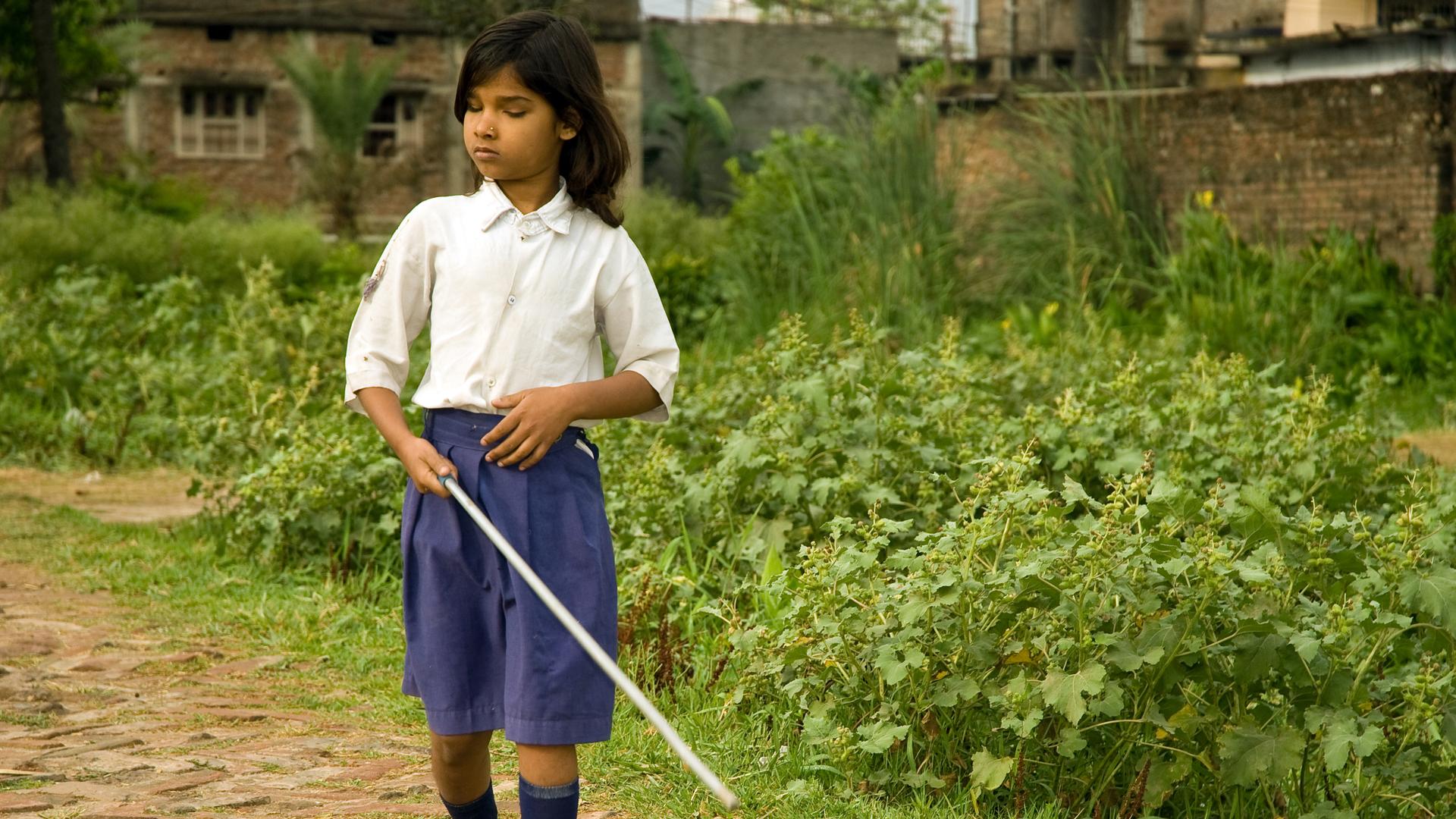 A girl named Kajal walks during mobility training at the Bihar Natraheen Parishad, or Bihar School for Blind Girls, in Patna, India, in 2009.