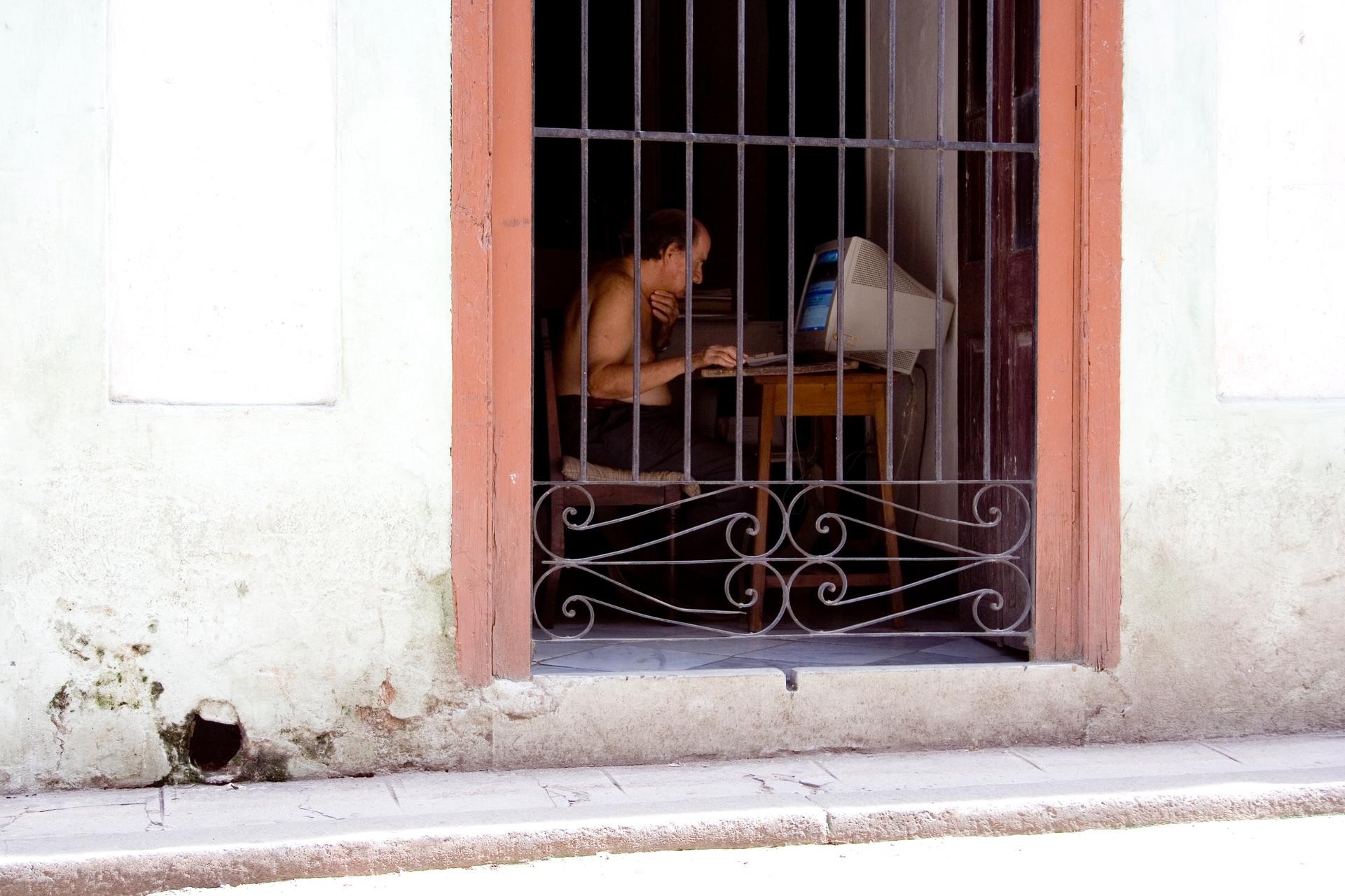 A Man Uses A Computer in Cuba
