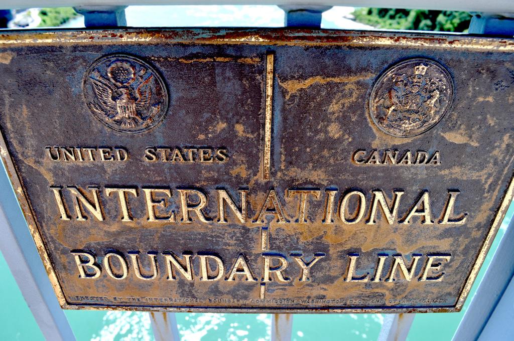 A sign marking the border between the United States and Canada at Niagara Falls.