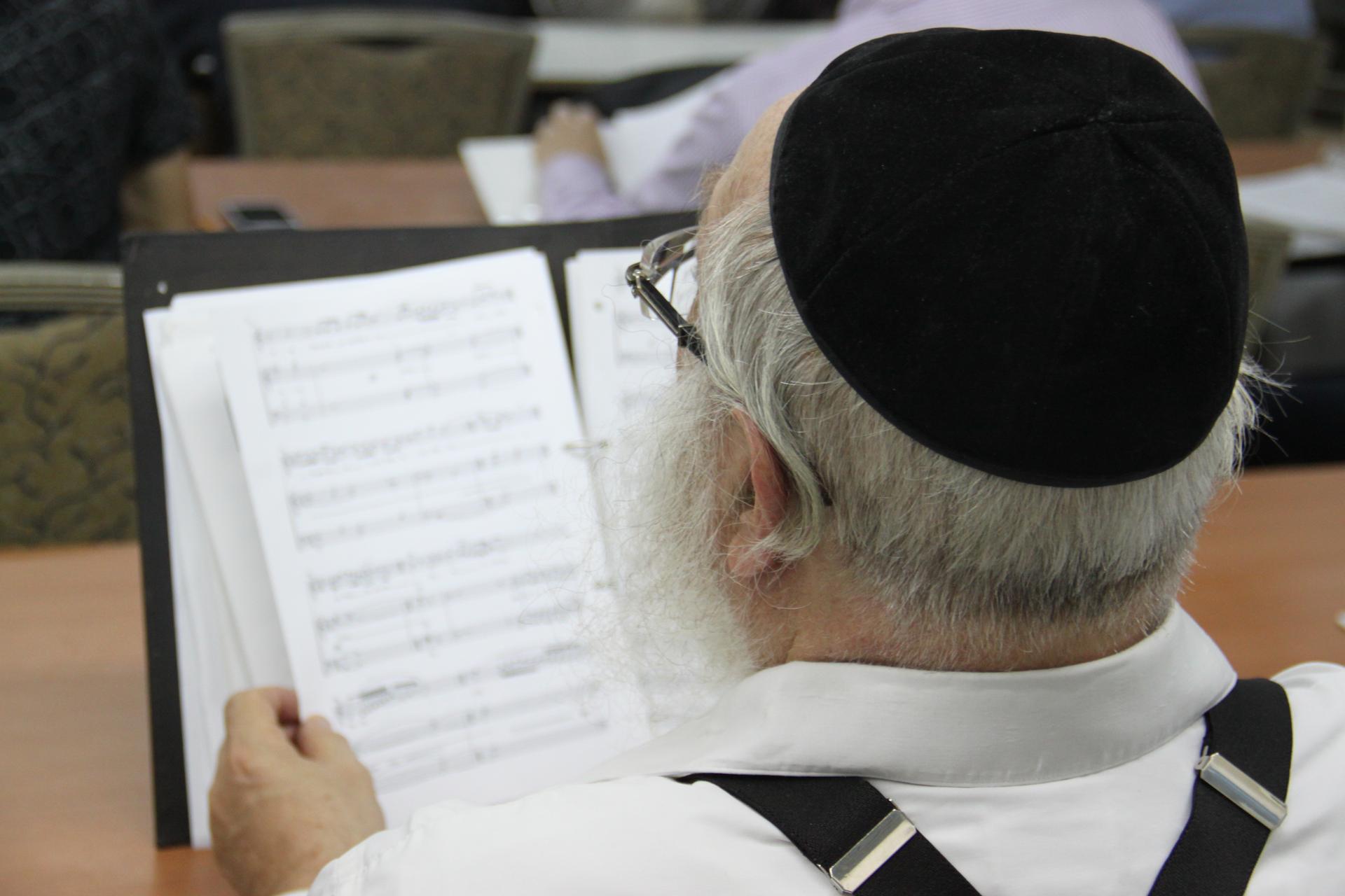 Cantor Chaim Adler looks over the sheet music from the Kol Nidre prayer, sung on the eve of Yom Kippur, the Jewish Day of Atonement.