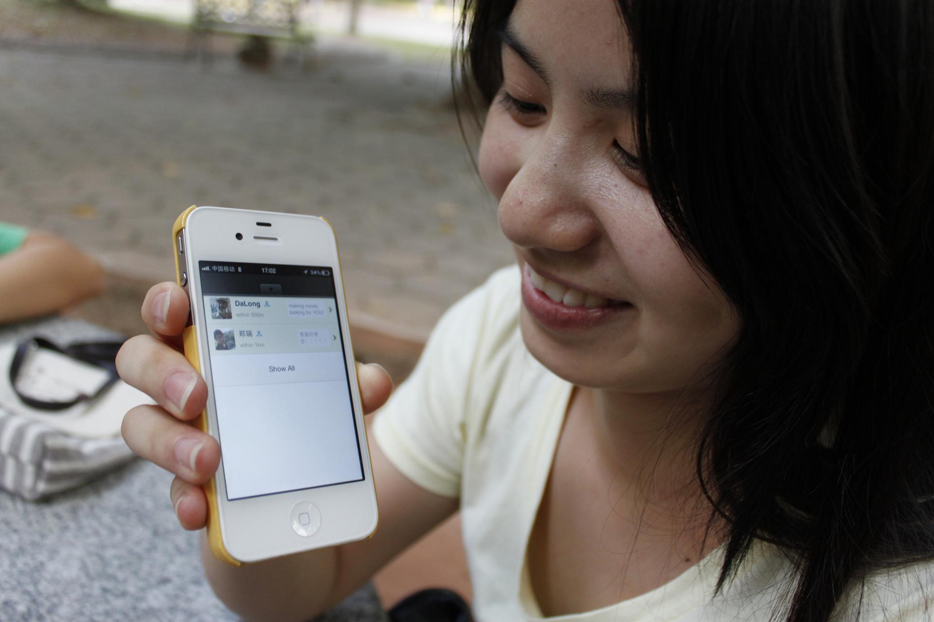 A WeChat user shows off the popular app on her phone.