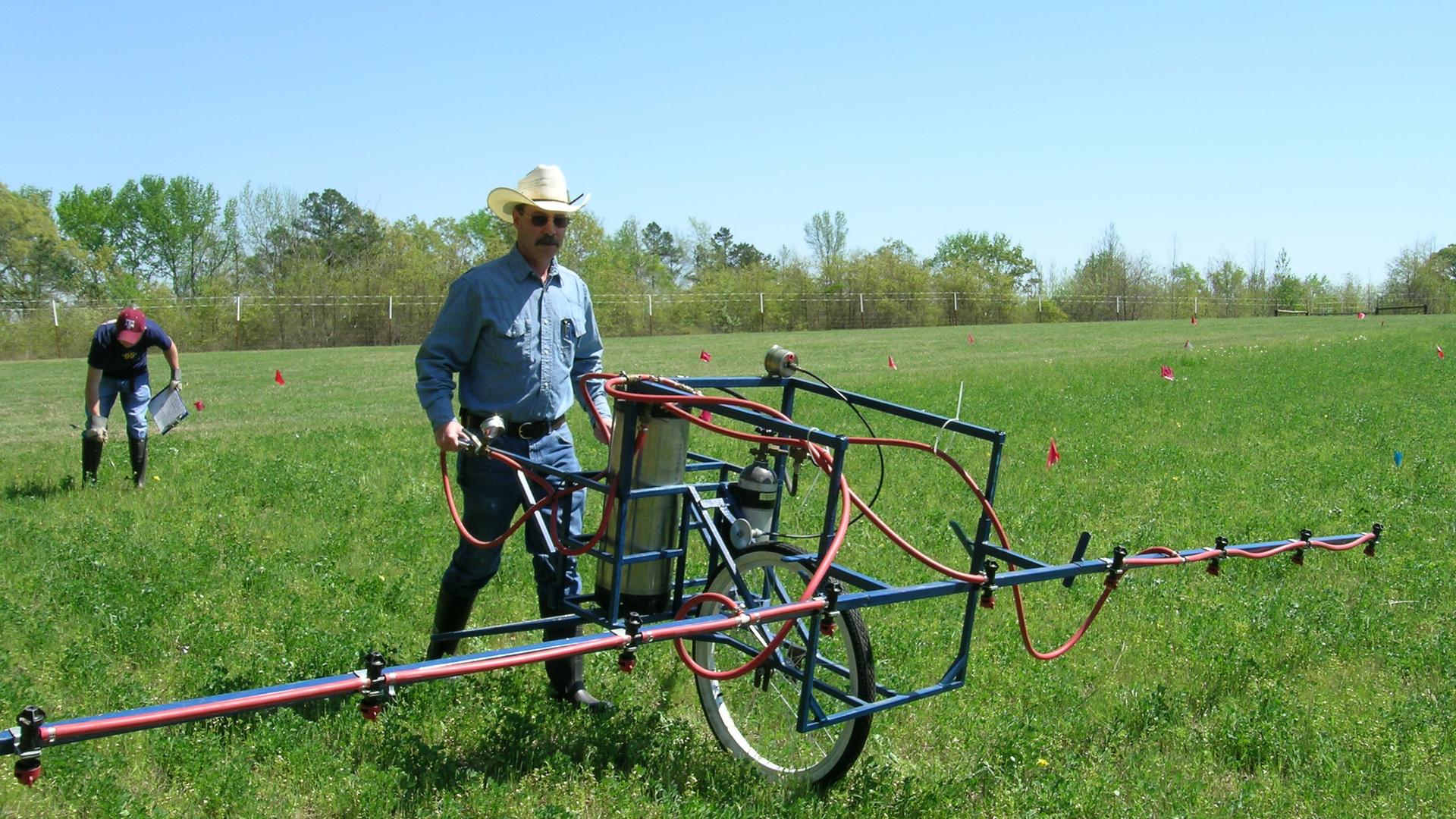Allen Leonard, research associate with Texas A&M AgriLife Research, uses a custom spray rig to apply herbicide to Roundup Ready alfalfa test plots.