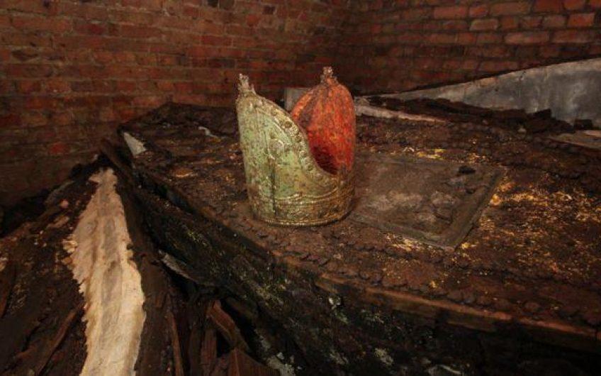 An archbishop's mitre rests on its owner's ancient lead coffin in a forgotten tomb in London