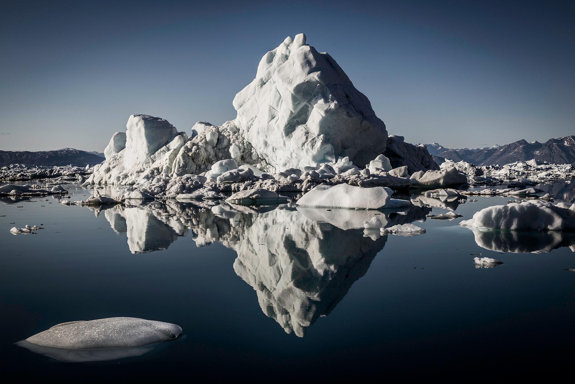 An iceberg from the Helheim Glacier in calm waters, Sermilik fjord, East Greenland.