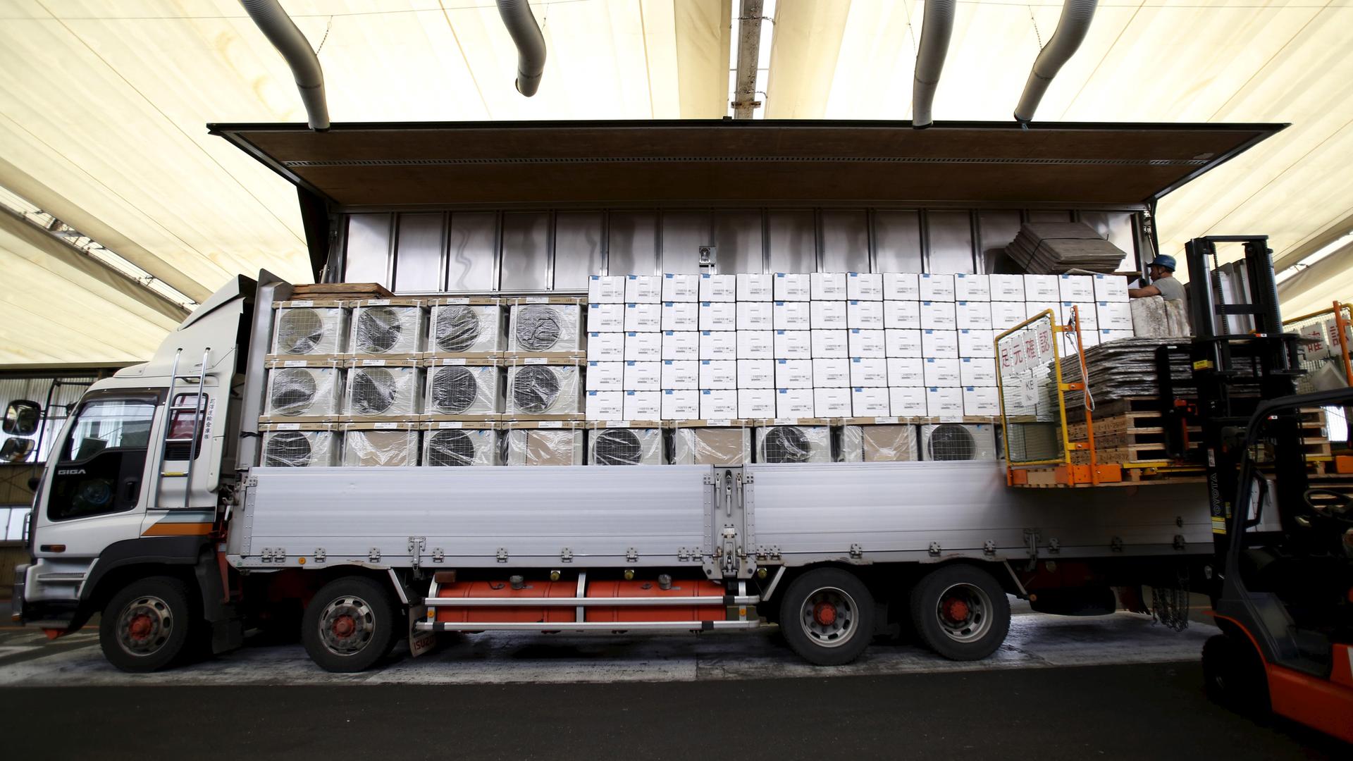 Air conditioners being loaded onto a truck for delivery. Most of the world's AC units cool air with chemicals that are big contributors to global warming. A new agreement forged in Kigali, Rwanda, will phase those coolants out over then next 30 years.