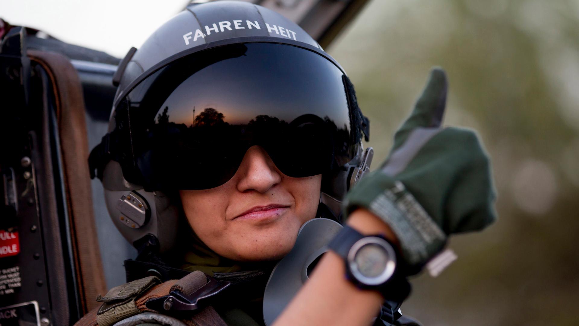 Ayesha Farooq, 26, Pakistan's only female war-ready fighter pilot, gives the thumb-up sign from the cockpit of a Chinese-made F-7PG fighter jet at Mushaf base in Sargodha, north Pakistan June 6, 2013.