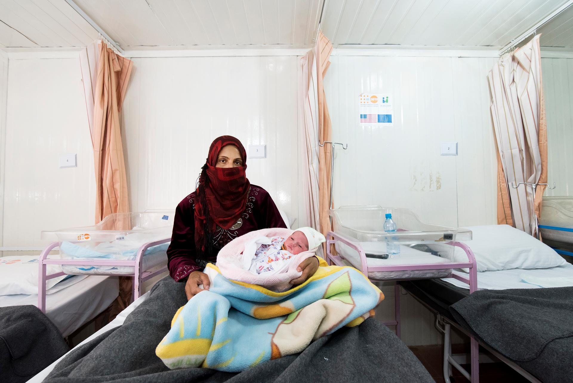 Um Mohammed and her newborn daughter called Shafagh at the maternity clinic in Zaatari refugee camp. The clinic is run by the Jordanian Health Aid Society and United Nations Population Fund.